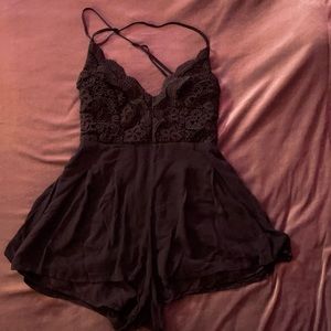 Lulu’s Star Spangled Black Backless Lace Romper.